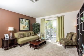 a living room with a couch chair and coffee table  at Bay Pointe Apartments, Lafayette
